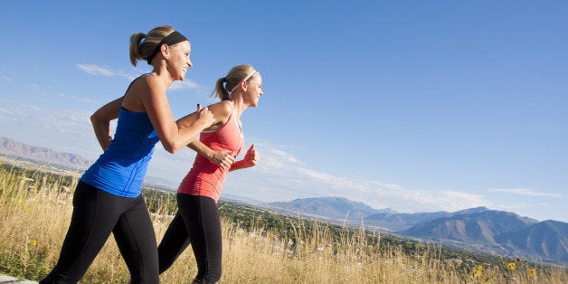 side view of two female joggers ...