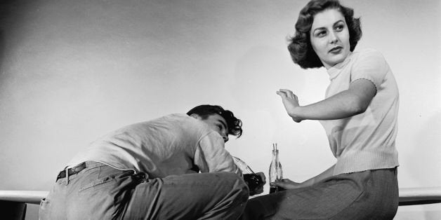 circa 1955: A girl is horrified by her boyfriend's posture while they are out on a date. (Photo by Orlando /Three Lions/Getty Images)