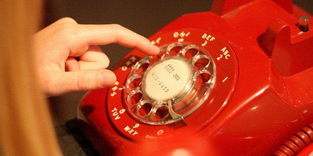 241/265 Elly learning to dial a rotary phone at a museum today.