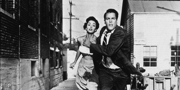 Becky Driscoll (German-born actress Dana Wynter) and Dr. Miles Bennell (American actor Kevin McCarthy) hold hands and run fro