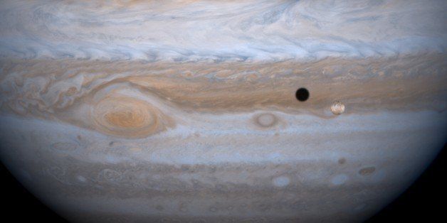 Jupiter and it's largest satellite, Io. Cassini Spacecraft. (Photo by: Universal History Archive/UIG via Getty Images)