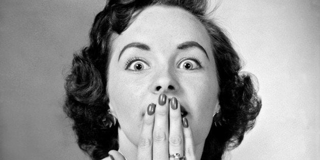 A woman has her hand over her mouth trying to stop her hiccups, Detroit, Michigan, September 10, 1957. (Photo by Underwood Archives/Getty Images)