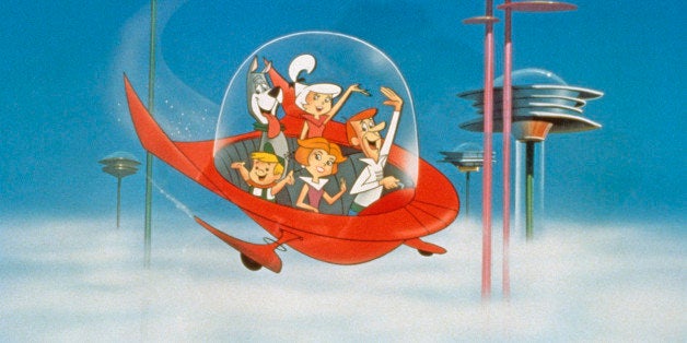 The Jetson family wave as they fly past buildings in space in their spaceship in a still from the animated television series, 'The Jetsons,' circa 1962. (Photo by Warner Bros./Courtesy of Getty Images)