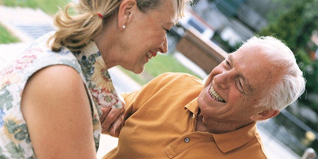 An elderly couple sit outside and enjoy a drink at a local bar in this arranged photograph taken in the Riverside area of Norwich, Norfolk, in May, 2000. (Photo by Bryn Colton/Getty Images)