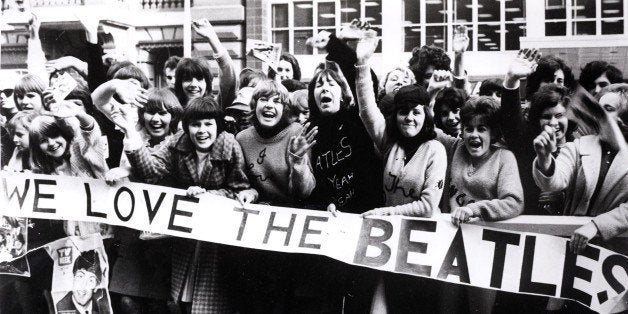 AUSTRALIA - JUNE 01: (AUSTRALIA OUT) Photo of SCREAMING FANS and BEATLES FANS and BEATLES and 60's STYLE; screaming Beatles fans holding banners and waving at band (Photo by GAB Archive/Redferns)