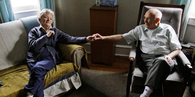 Alzheimer's patient Dorothy Eckert and her husband John Eckert's hold hands at their home in Norristown Pa., Thursday, April