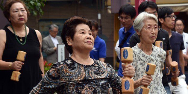 Elderly residents work out with wooden dumb-bells in the grounds of a temple in Tokyo on September 15, 2014 to celebrate Japan's Respect-for-the-Aged-Day. The number of people aged 65 or older in Japan is at a record 32.96 million, accounting for an all-time high of 25.9 percent of the nation's total population, the government announced. AFP PHOTO / Yoshikazu TSUNO (Photo credit should read YOSHIKAZU TSUNO/AFP/Getty Images)