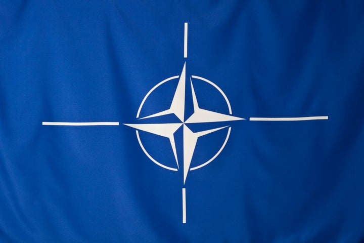 North Atlantic Treaty Organization flag, white compass rose emblem in blue background