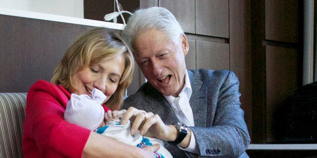 This photo provided by Clinton spokesman Kamyl Bazbaz shows former Secretary of State Hillary Rodham Clinton, left, and former President Bill Clinton, right with their granddaughter Charlotte Clinton Mezvinsky on Saturday, Sept. 27, 2014, at Lenox Hill Hospital in New York. The Clintons's daughter, Chelsea, gave birth Friday night to her first child, Charlotte. (AP Photo/Office of President Clinton, Jon Davidson)