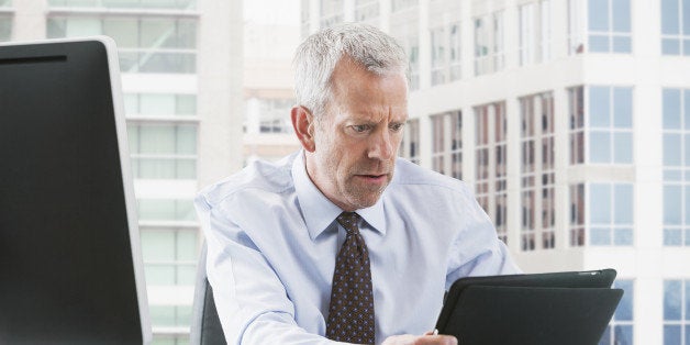 Caucasian businessman using tablet computer