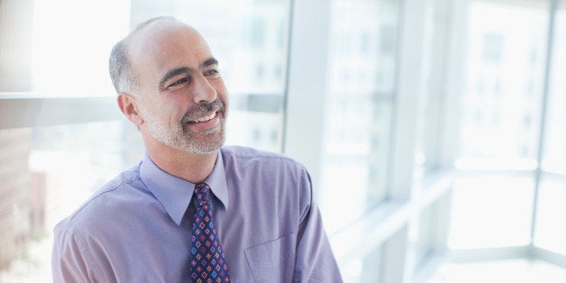 Smiling businessman sitting in office