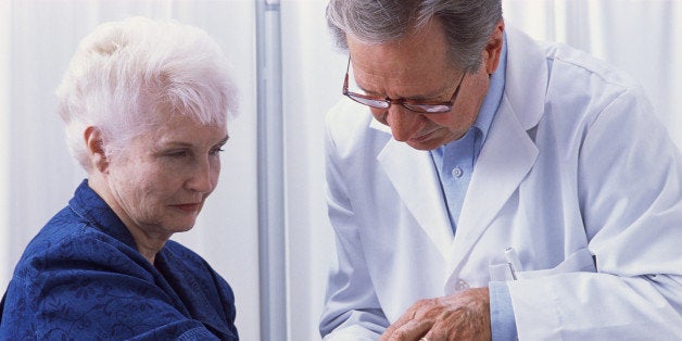 Dermatologist examining woman's skin