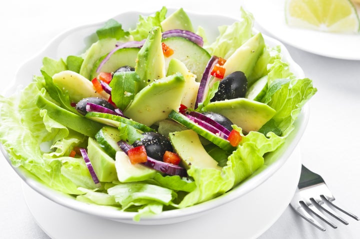 Salad with avocado, black olives, red onion and cucumber