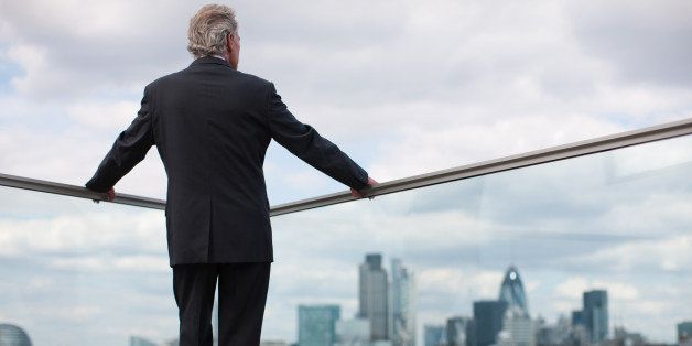 Businessman standing on urban balcony
