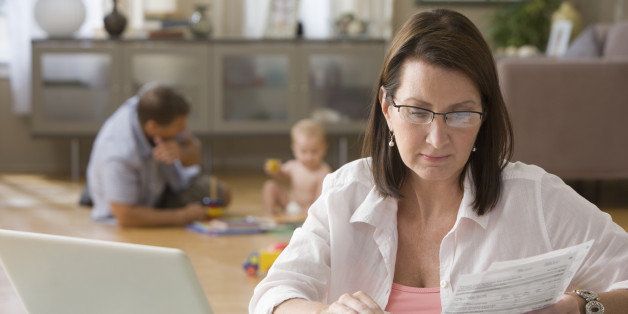 Caucasian woman paying bills on computer
