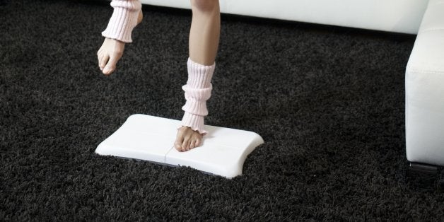 Young woman practicing gym with Wii Fit