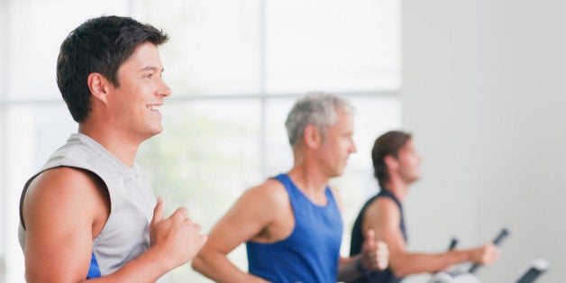 Men running on treadmills in gymnasium