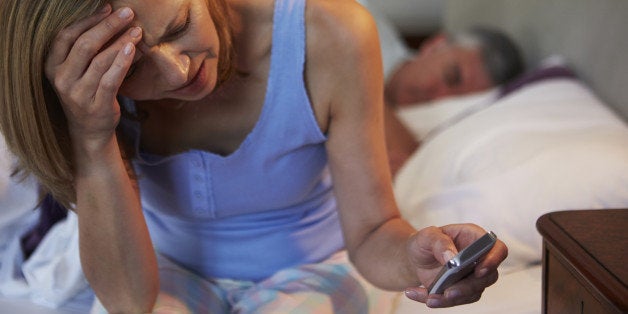 Couple In Bed With Wife Suffering From Insomnia Late At Night