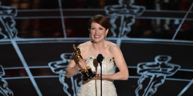 Julianne Moore accepts the award for best actress in a leading role for âStill Alice at the Oscars on Sunday, Feb. 22, 2015, at the Dolby Theatre in Los Angeles. (Photo by John Shearer/Invision/AP)