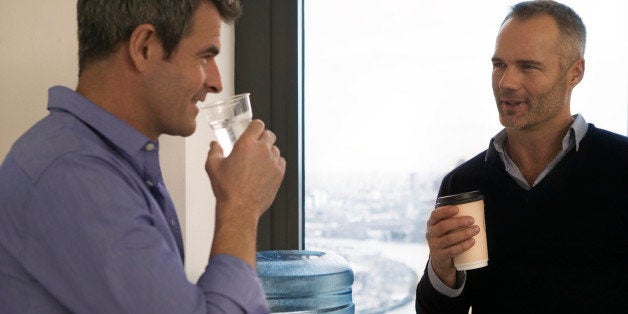 Office collegues on break at water cooler