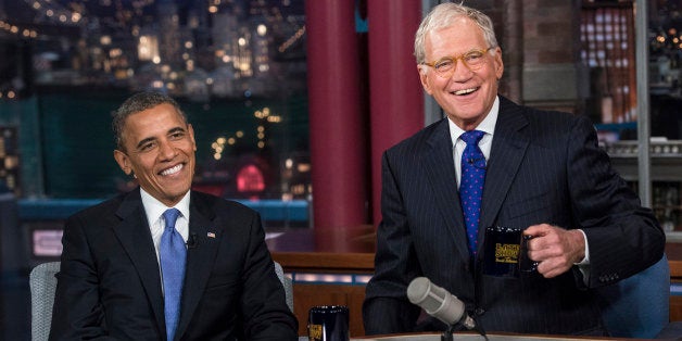 US President Barack Obama and David Letterman speak during a break in the taping of the 'Late Show with David Letterman' at t