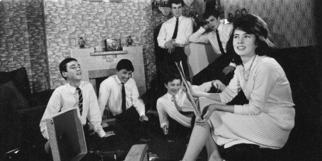 circa 1960: A group of teenagers listening to some records at home. (Photo by Keystone/Getty Images)