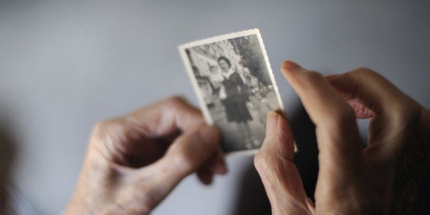 A woman, suffering from Alzheimer's desease, looks at an old picture of herself on March 18, 2011 in a retirement house in An
