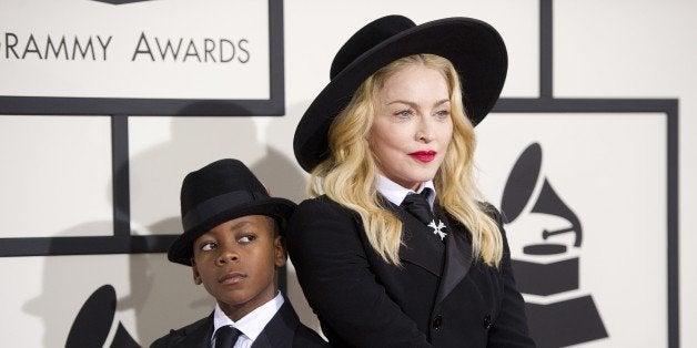 Madonna and her eight-year-old son David Banda pose on the red carpet for the 56th Grammy Awards at the Staples Center in Los Angeles on January 26, 2014. AFP PHOTO/ROBYN BECK (Photo credit should read ROBYN BECK/AFP/Getty Images)