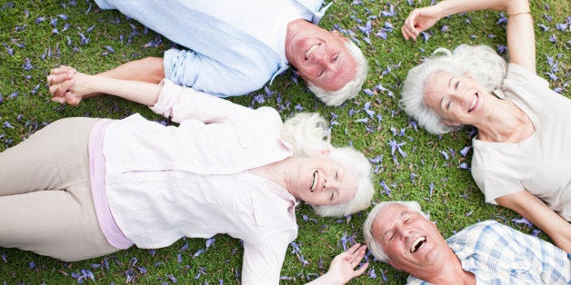 Senior couples laying on grass