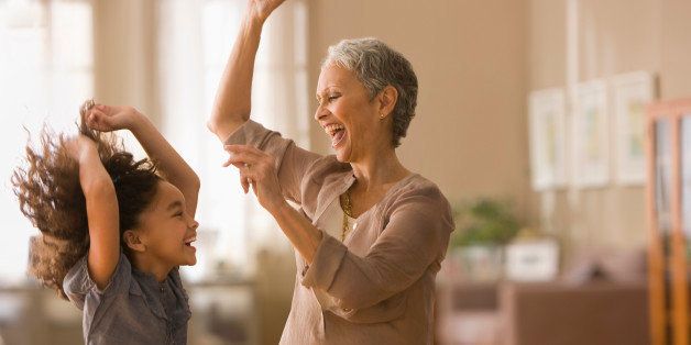 Grandmother and granddaughter dancing together