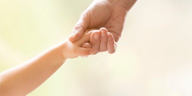 Young girl holding the hand of an elderly person