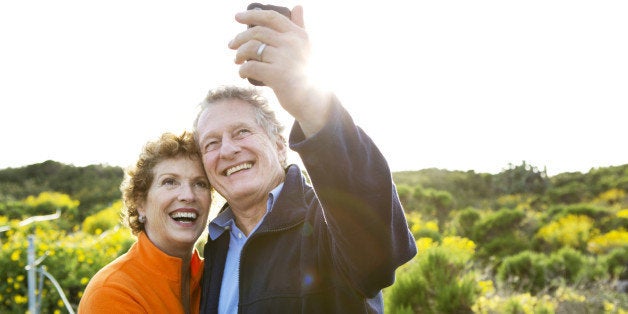 Caucasian couple taking picture outdoors