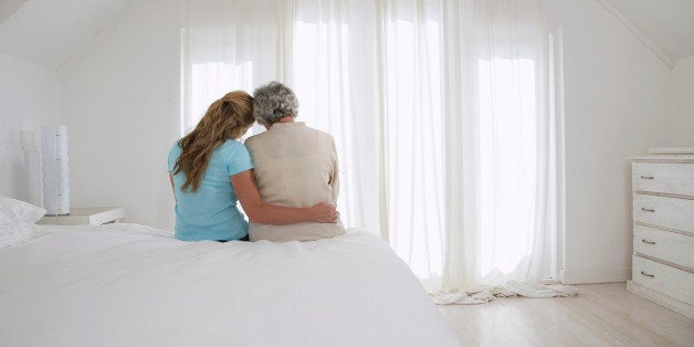 Mother and Daughter Sitting on Bed