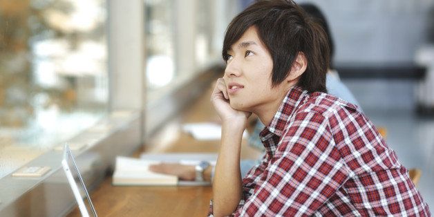 College Student daydreaming when he should be studying. iStockalypse Tokyo 2010.