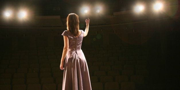back view girl in long gown performing on stage
