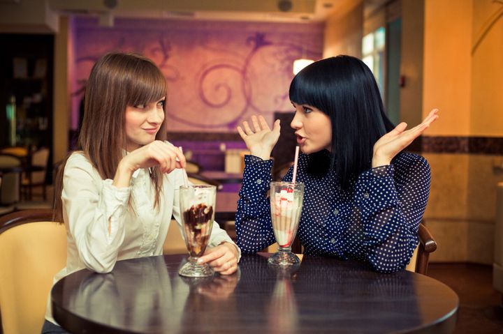 two women speaking in caffee