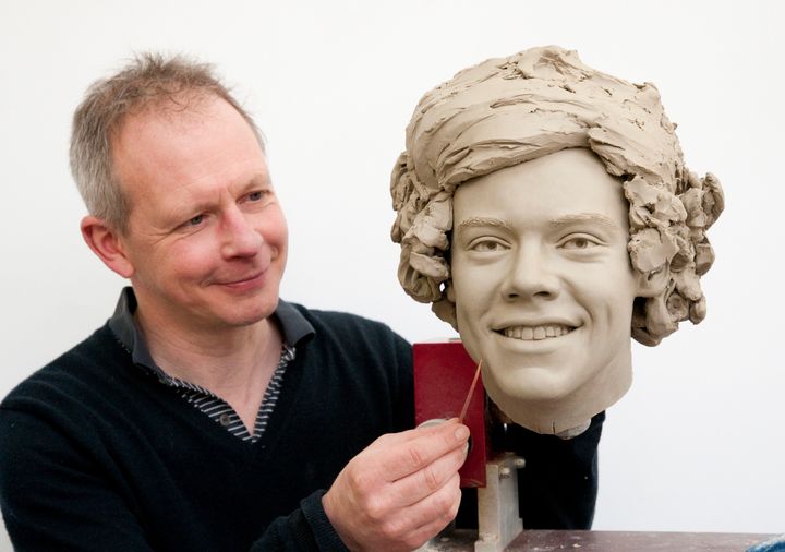 UNSPECIFIED LOCATION - UNSPECIFIED DATE: In this handout image provided by Madame Tussauds, sculptor Jim Kemp works on the clay head of Harry Styles of One Direction. Madame Tussauds announced on March 11, 2013 that the world famous wax attraction will immortalize the band by creating five individual wax figures of each member. The figures are being created in full cooperation with the band and will be part of a traveling exhibit that will launch in London on April 18 before traveling to New York, July 19 - October 11, and Sydney, October 24 - January 28. (Photo by Madame Tussauds via Getty Images)