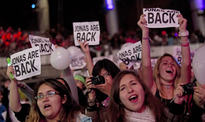 Fans of the American pop rock band Jonas Brothers enjoy the band performace at the 54th Vina del Mar International Song Festival on February 26, 2013 in Vina del Mar, Chile. AFP PHOTO/MARTIN BERNETTI (Photo credit should read MARTIN BERNETTI/AFP/Getty Images)