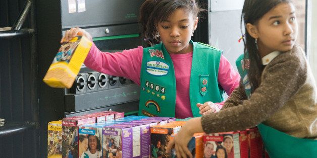 UPPER MARLBORO, MD - FEBRUARY 26: Girl scouts sell cookies at Freeman's Barber Shop in Upper Marlboro, MD. Lalah Williams, left, 10, of Upper Marlboro, MD, is helping sell the cookies, but has also utilized the internet to become one of the top sellers in the area. Hilary Foinding, 9, of Upper Marlboro, MD is on the right. (Photo by Sarah L. Voisin/The Washington Post via Getty Images)