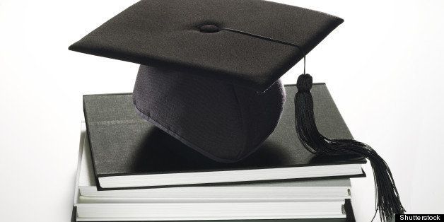 Description: A graduation hat sitting on a stack of books.