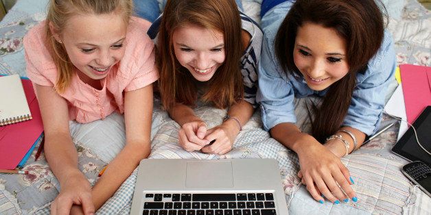 Teenage girls looking at laptop