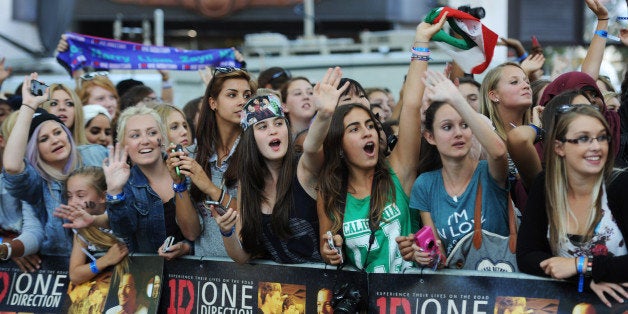 LONDON, ENGLAND - AUGUST 20: Fans attend the world premiere of 'One Direction - This Is Us' at The Empire Leicester Square on August 20, 2013 in London, England. (Photo by Dave J Hogan/Getty Images)