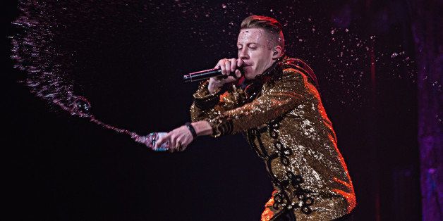 SEATTLE, WA - DECEMBER 11: Macklemore of Macklemore and Ryan Lewis performs on stage at KeyArena on December 11, 2013 in Seattle, Washington. (Photo by Mat Hayward/Getty Images)