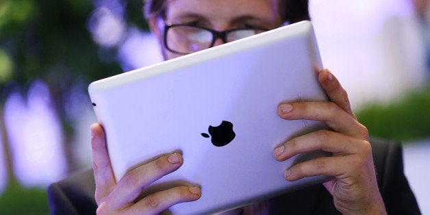 A businessman uses an Apple Inc. iPad tablet on the closing day of the St. Petersburg International Economic Forum (SPIEF) in