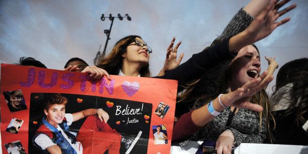 Fans await the arrival of Justin Bieber at the world premiere of 'Justin Bieber's BELIEVE,' December 18, 2013 at the Regal Cinemas at LA Live in Los Angeles, California. The film opens nationwide on Christmas Day. AFP PHOTO / Robyn Beck (Photo credit should read ROBYN BECK/AFP/Getty Images)