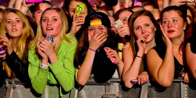Young fans of Canadian singer Justin Bieber attend his concert as part of the 'Believe Tour' at Telenor Arena in Fornebu, Norway on April 16, 2013. AFP PHOTO / DANIEL SANNUM LAUTEN (Photo credit should read DANIEL SANNUM LAUTEN/AFP/Getty Images)