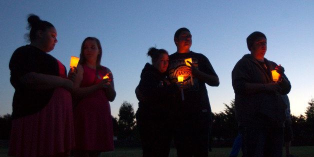 TROUTDALE, OR - JUNE 10: Friends, family and well-wishers hold candles for Emilio Hoffman, the victim of today's school shooting at a vigil on June 10, 2014 in Troutdale, Oregon. A gunman walked into Reynolds High School with a rifle and shot 14 year old Hoffman to death on Tuesday, in what is the the third outbreak of gun violence in a U.S. school in less than three weeks. (Photo by Natalie Behring/Getty Images)