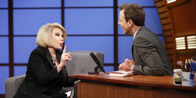 LATE NIGHT WITH SETH MEYERS -- Episode 081 -- Pictured: (l-r) Comeidan Joan Rivers during an interview with host Seth Meyers