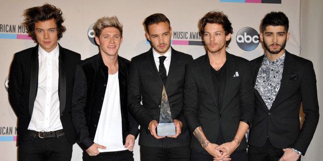 From left, Harry Styles, Niall Horan, Liam Payne, Louis Tomlinson, and Zayn Malik of the musical group One Direction pose backstage with the award for favorite album - pop/rock for "Take Me Home" and favorite band, duo or group - pop/rock at the American Music Awards at the Nokia Theatre L.A. Live on Sunday, Nov. 24, 2013, in Los Angeles. (Photo by Jordan Strauss/Invision/AP)