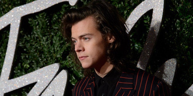 Harry Styles poses for photographers upon arrival at The British Fashion Awards 2014, in London, Monday, Dec. 1, 2014. (Photo by Jonathan Short/Invision/AP)